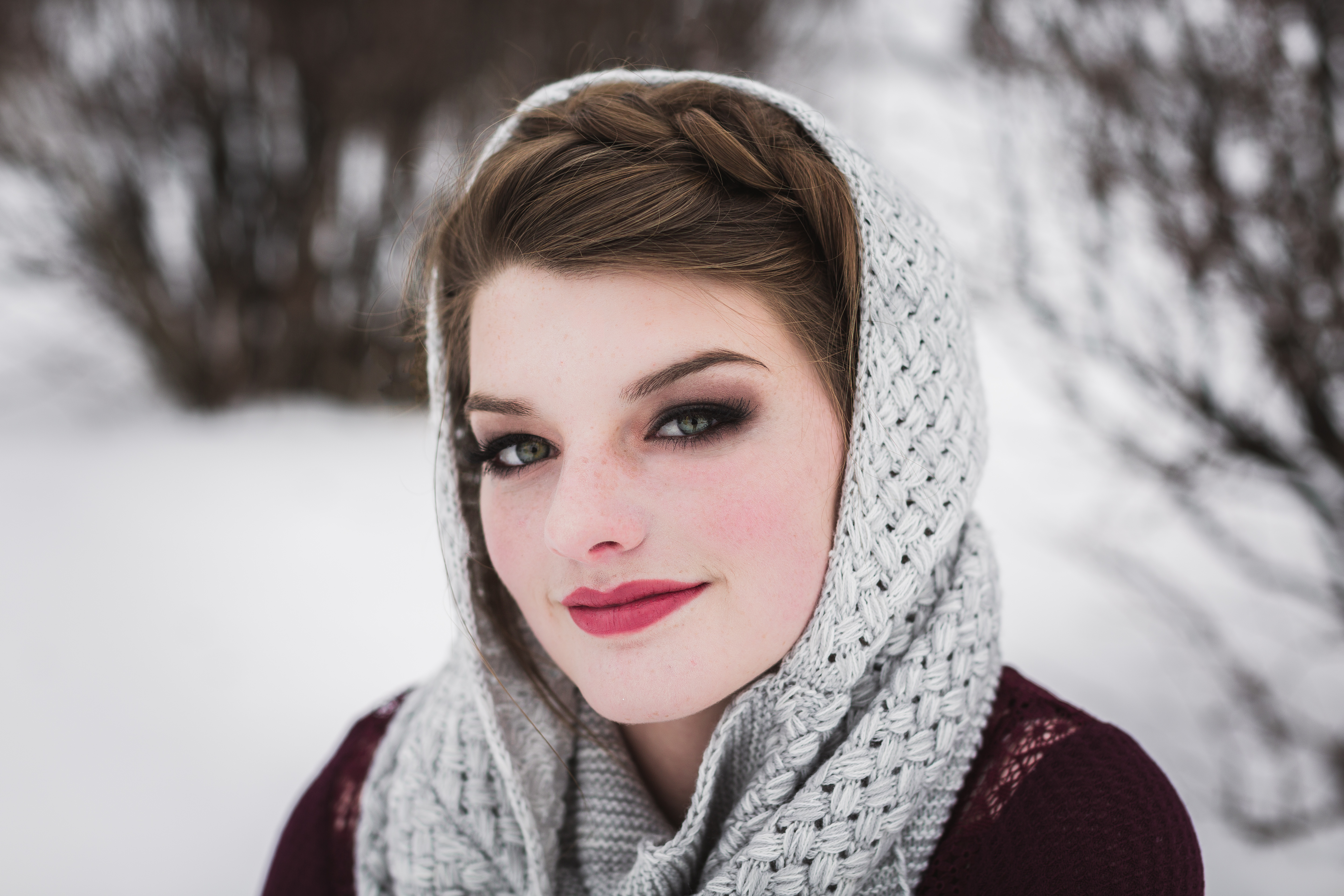 brunette senior girl with milkmaid braid and grey crocheted scarf draped on her head
