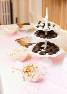 table with popcorn bar and white cake stand filled with chocolate covered Oreos at Little Birds Photography's Glitter & Glam Night