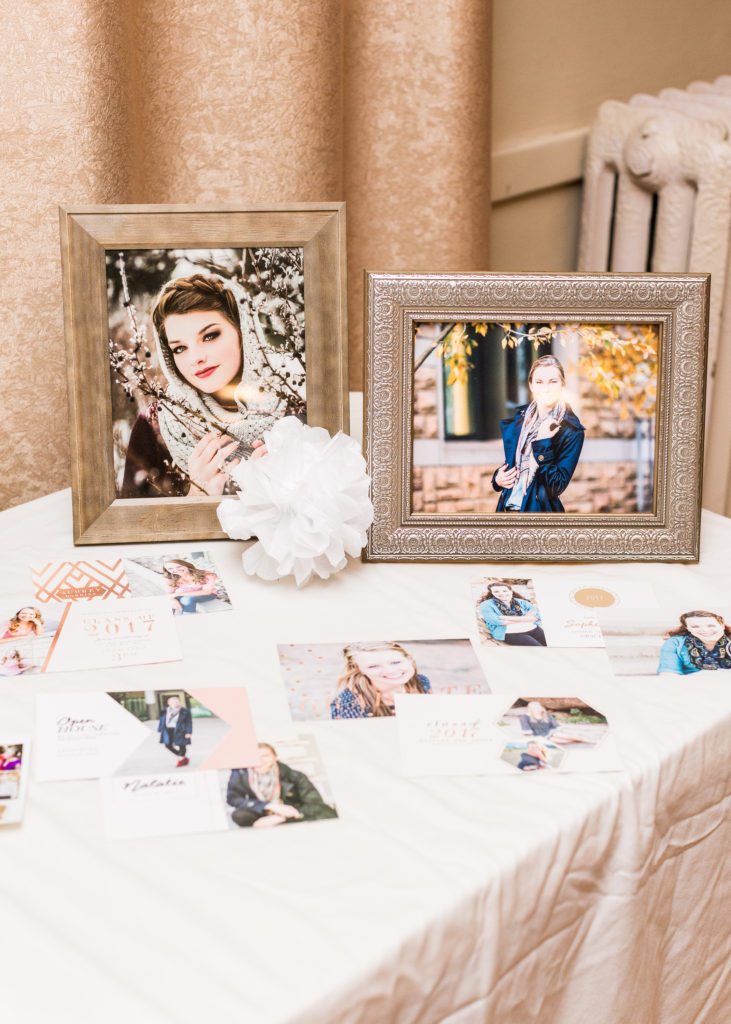 table displaying sample graduation announcements and senior photos at Little Birds Photography's Glitter & Glam Night