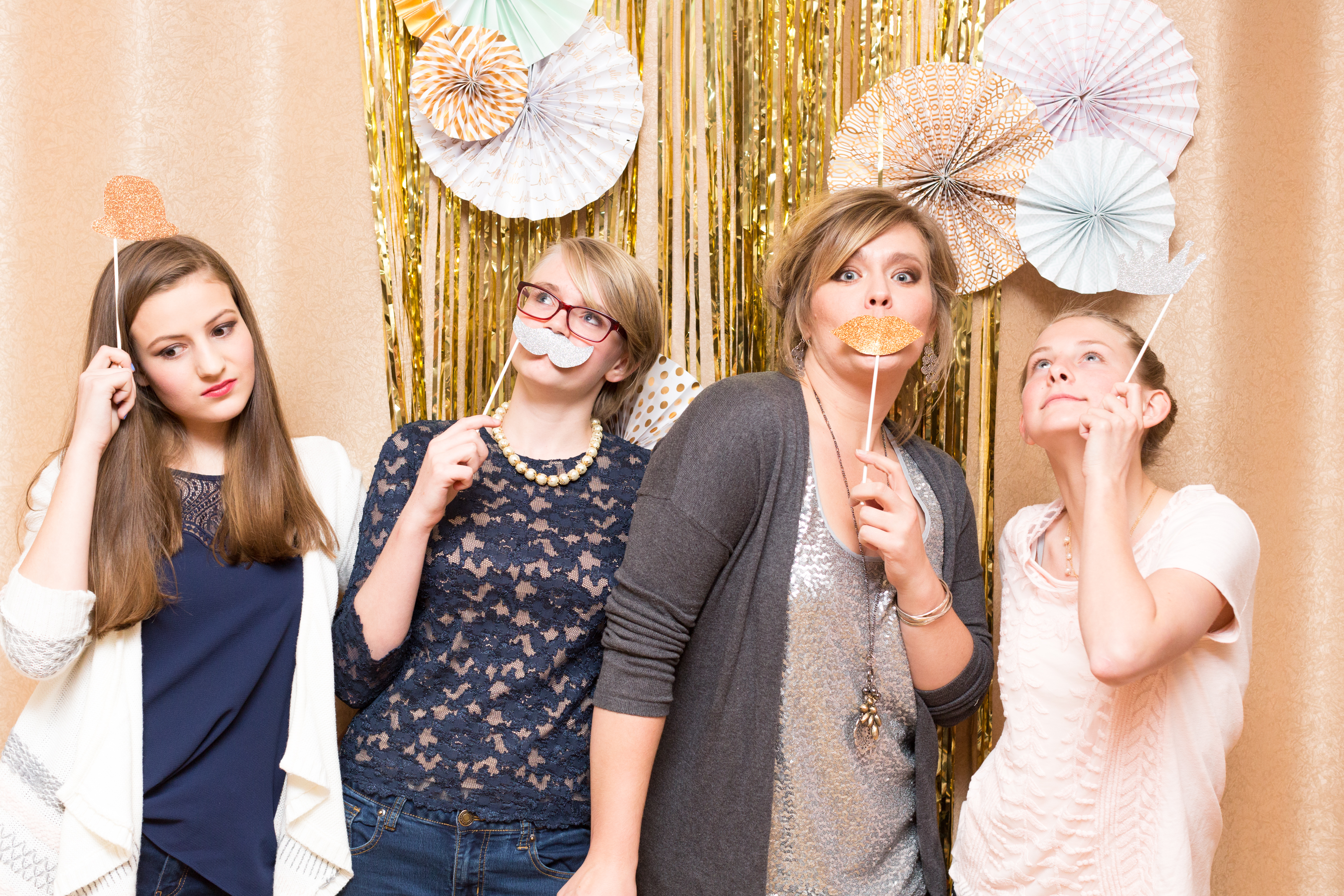 four girls posing in photo booth with props at Little Bird Photography's Glitter & Glam Night