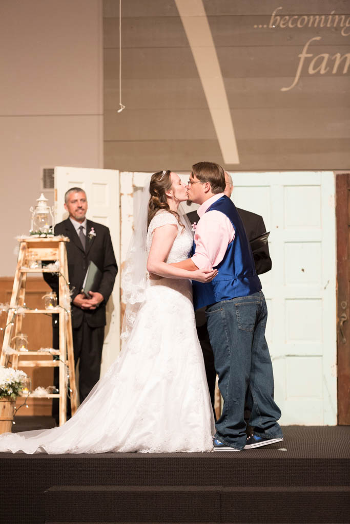 bride and groom kiss during their church ceremony 