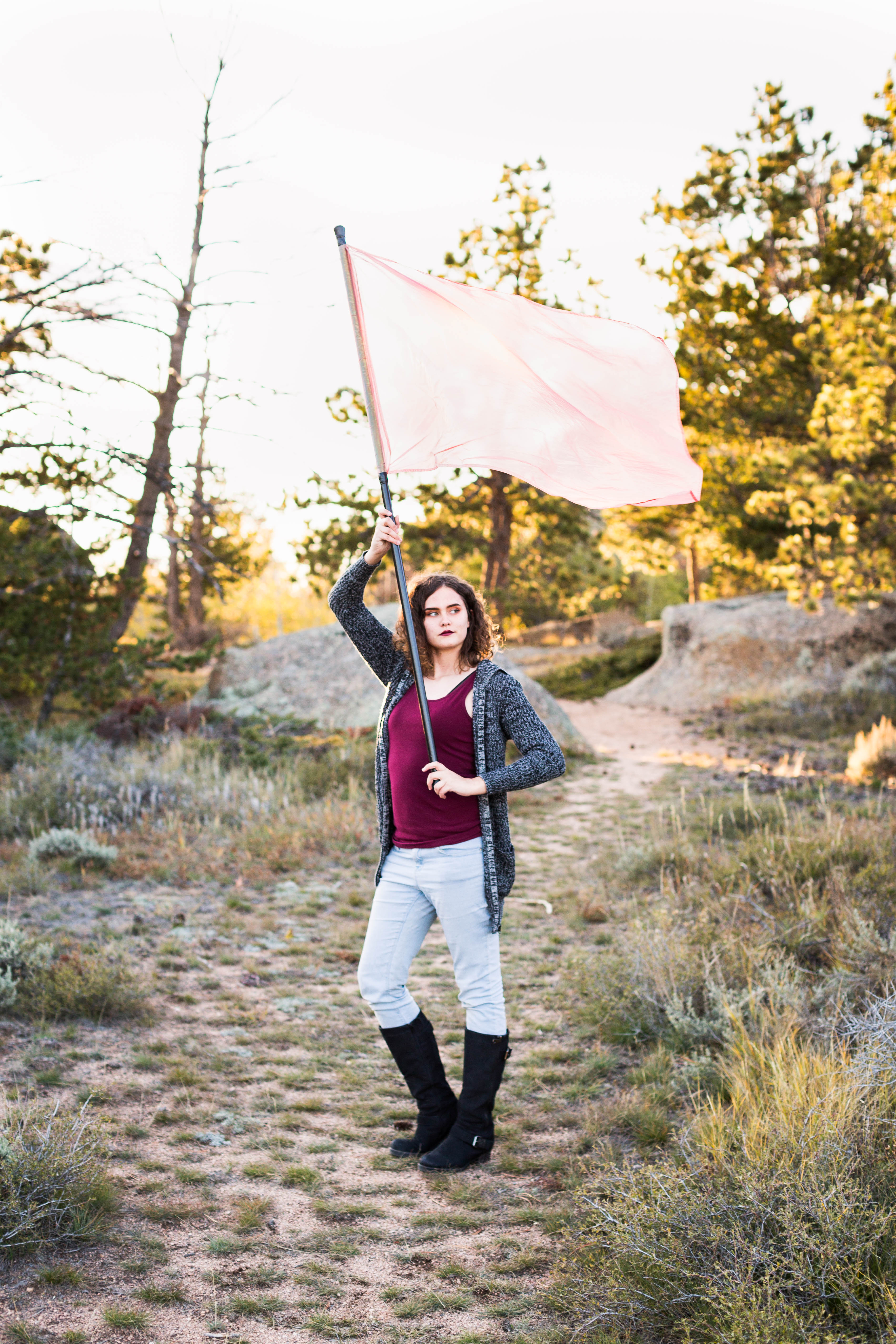 senior girl holding color guard flag at Vedauwoo Recreation Area