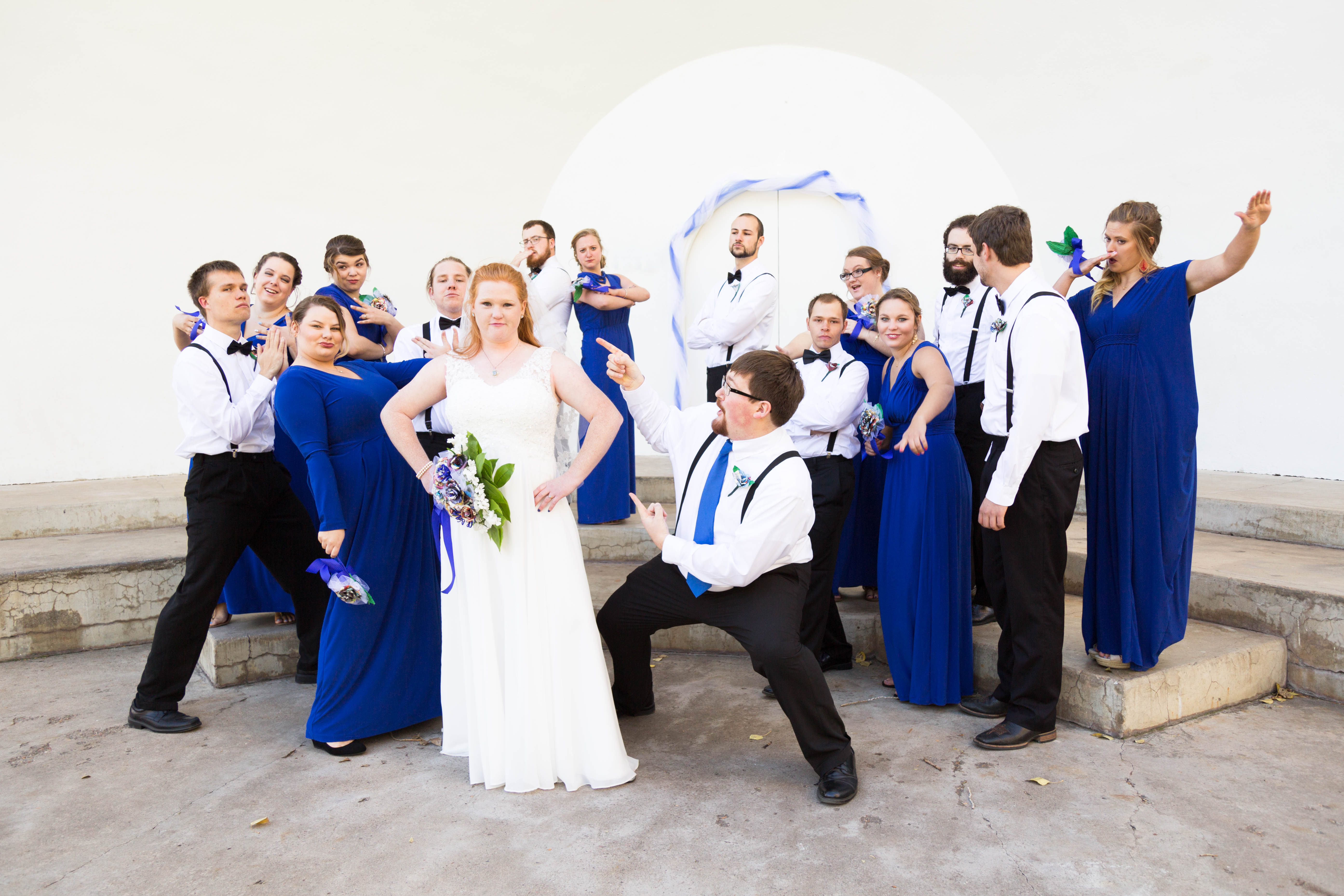 wedding party strikes a pose around bride and groom