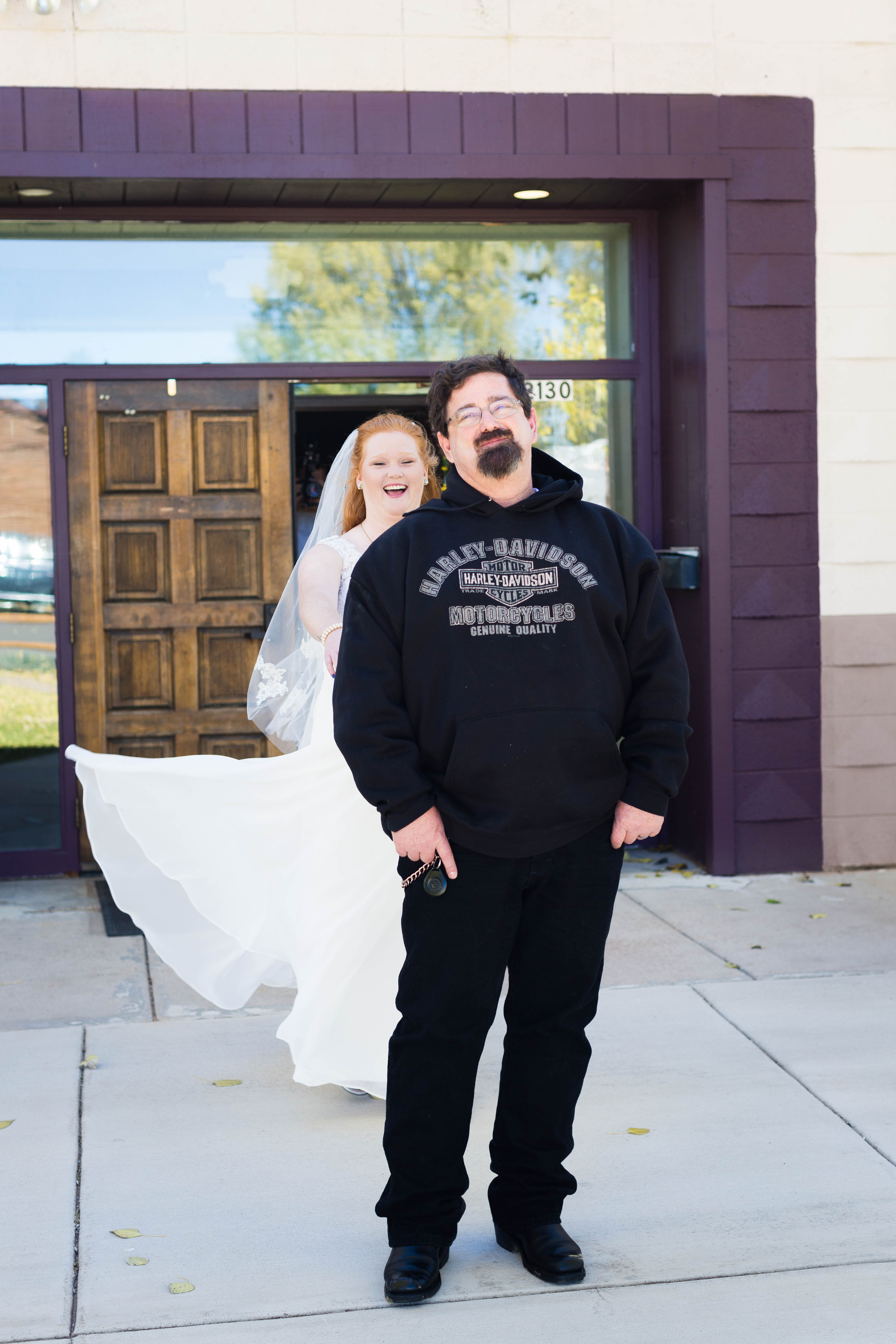 dad smiles before seeing his daughter in her wedding dress dor the first time