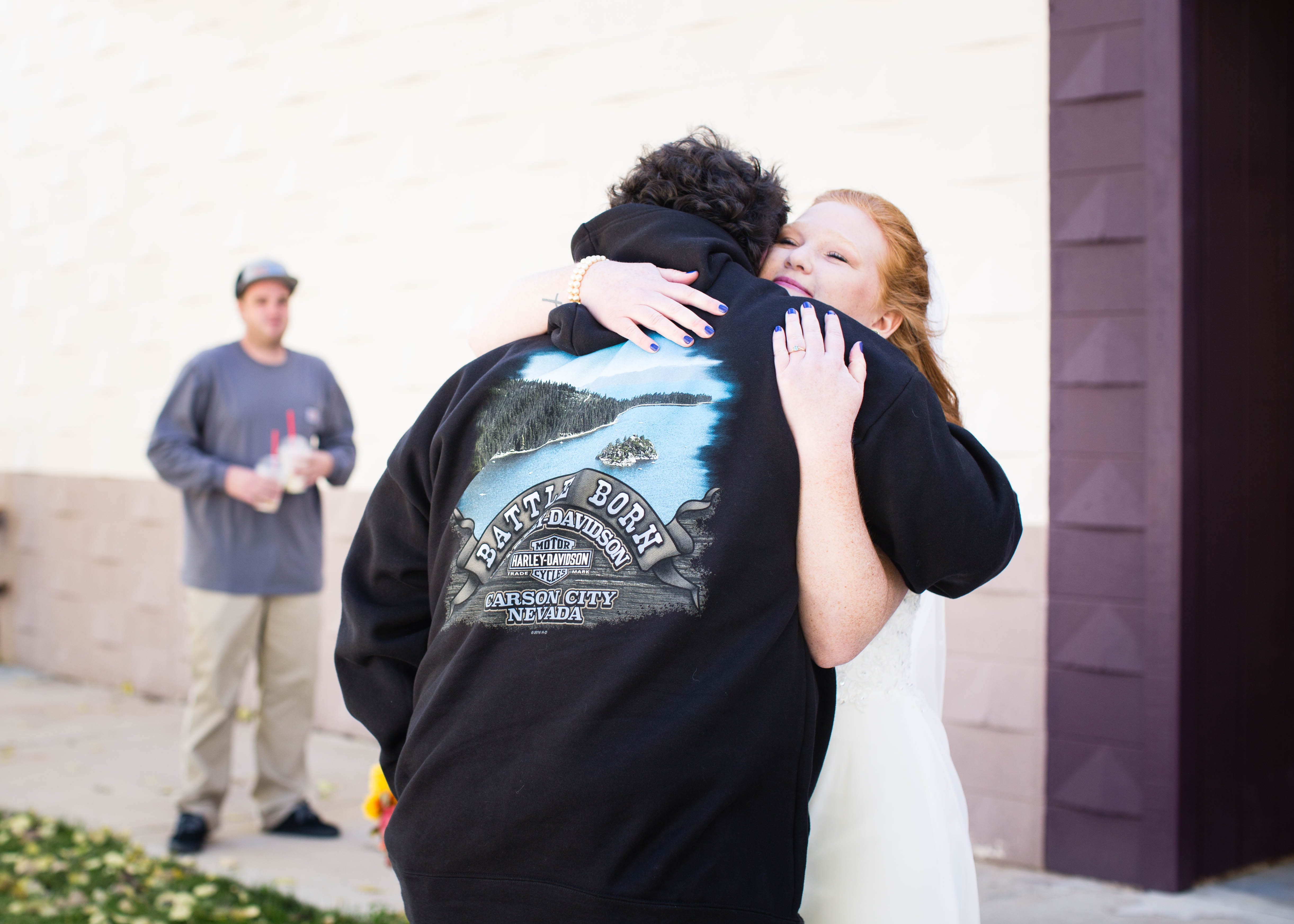 bride smiles as she hugs her dad after seeing him for the first time