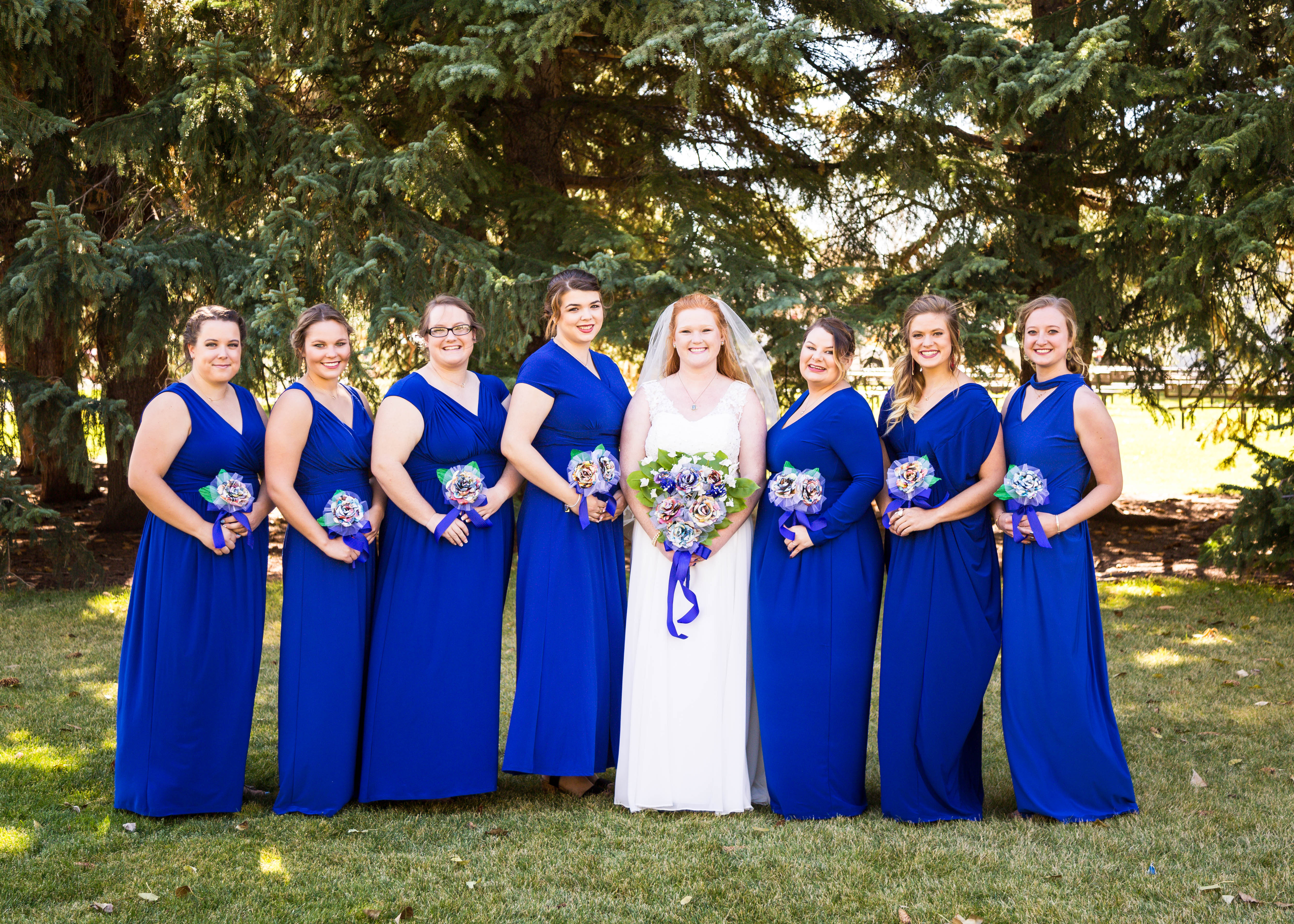 bride smiles surrounded by bridesmaids