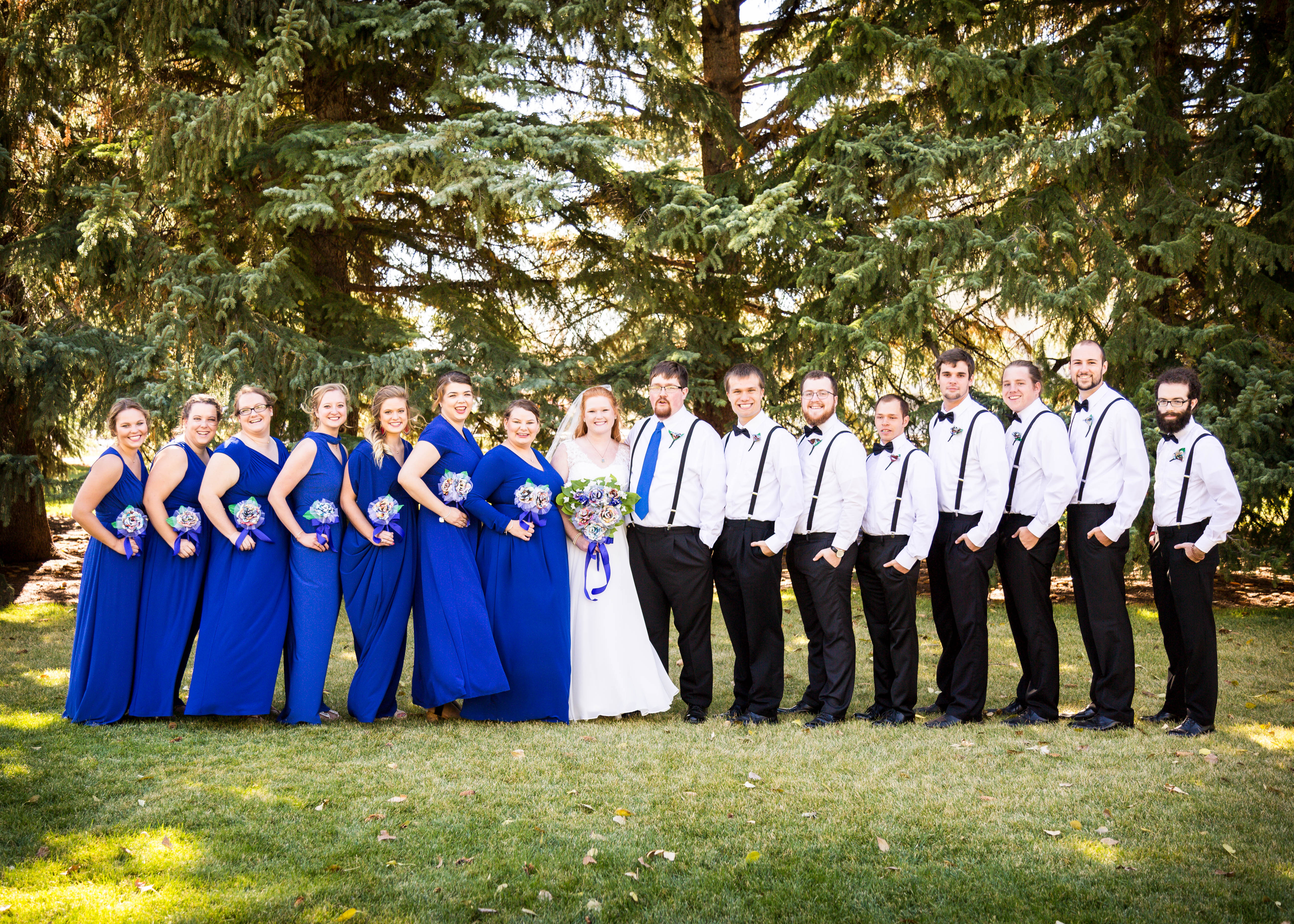 bride and groom pose with wedding party
