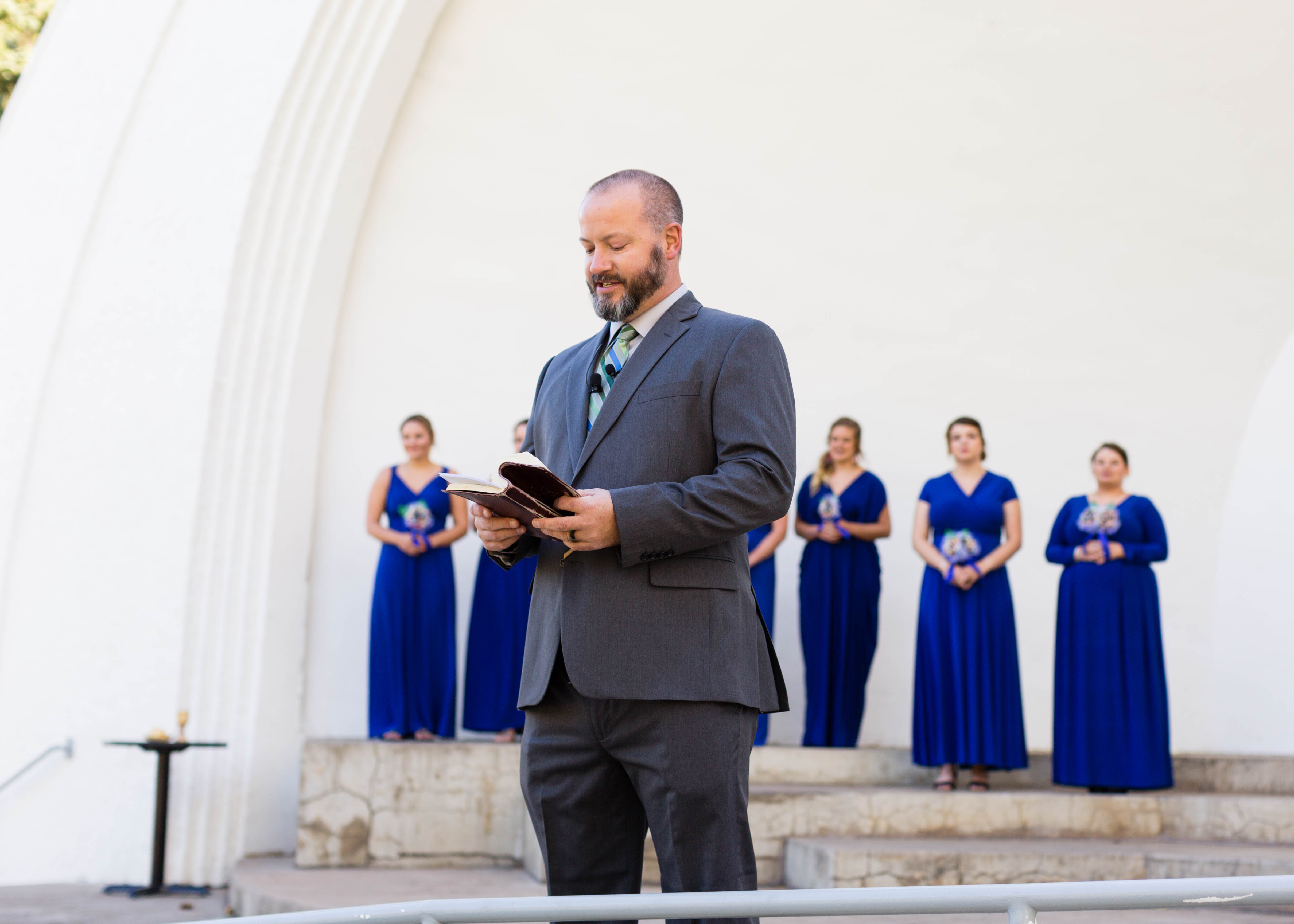 officiant reads from Bible at the beginning of wedding ceremony