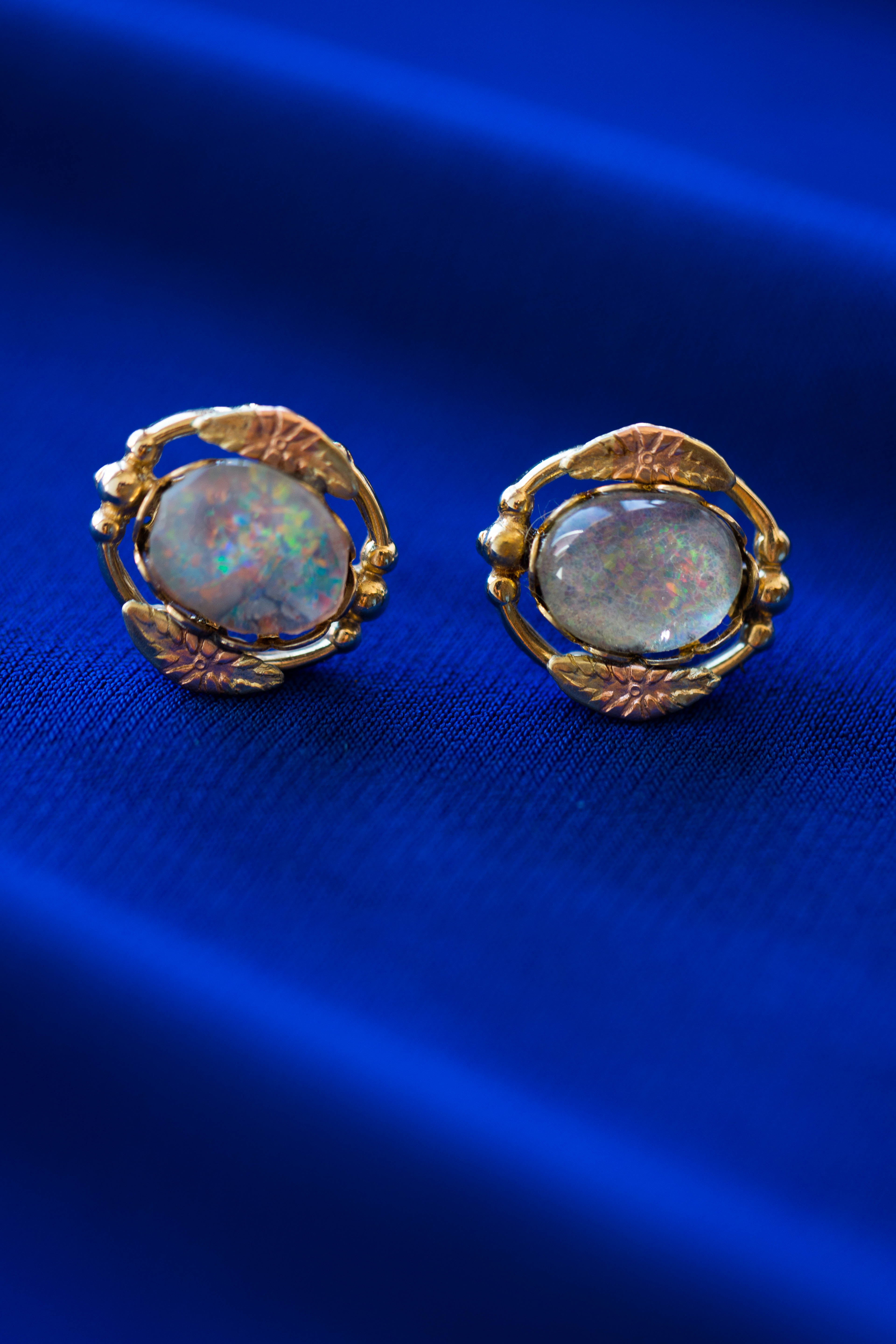 closeup of opal and gold pendant earrings
