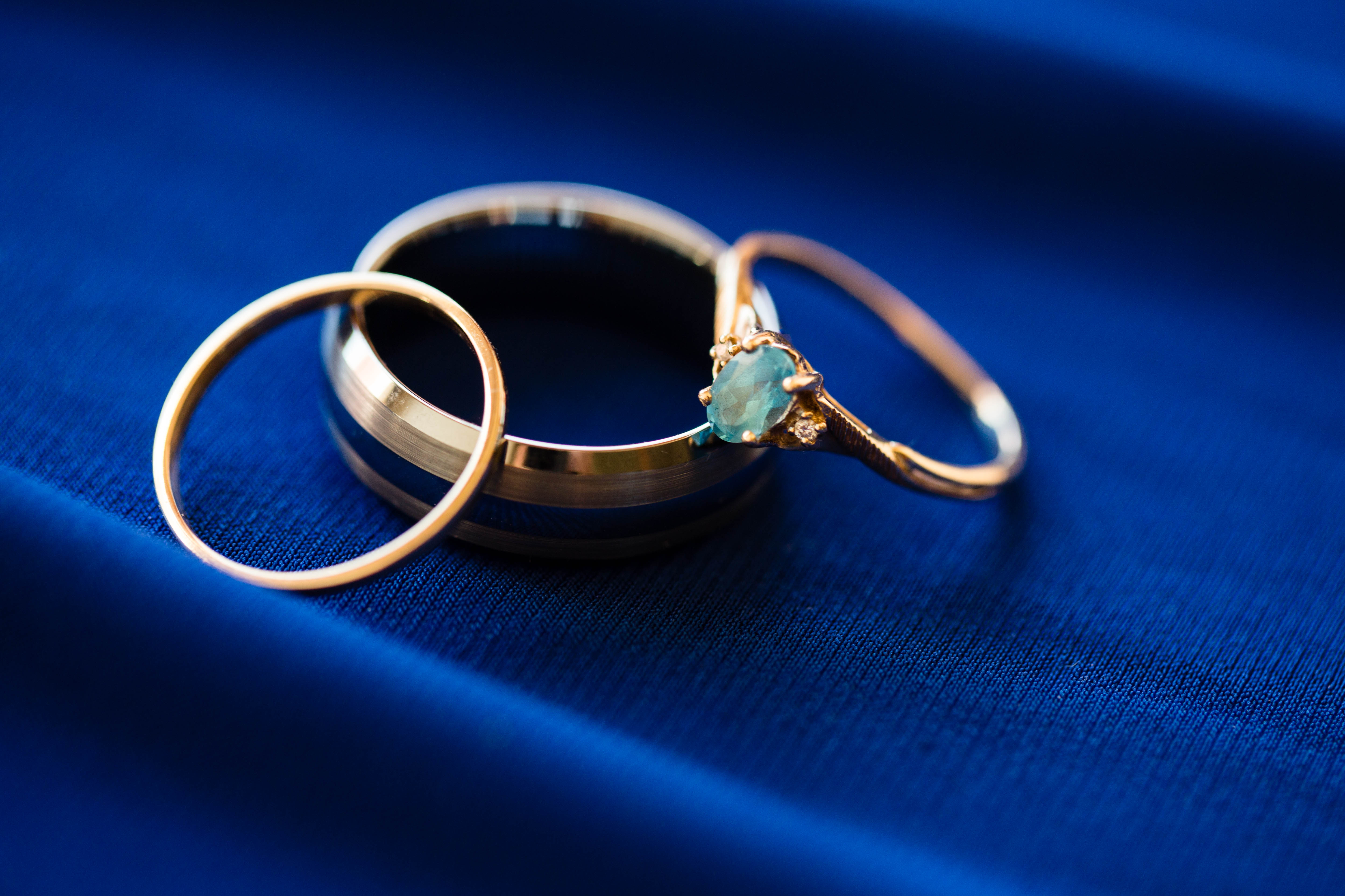 wedding rings stacked on royal blue bridesmaid dress