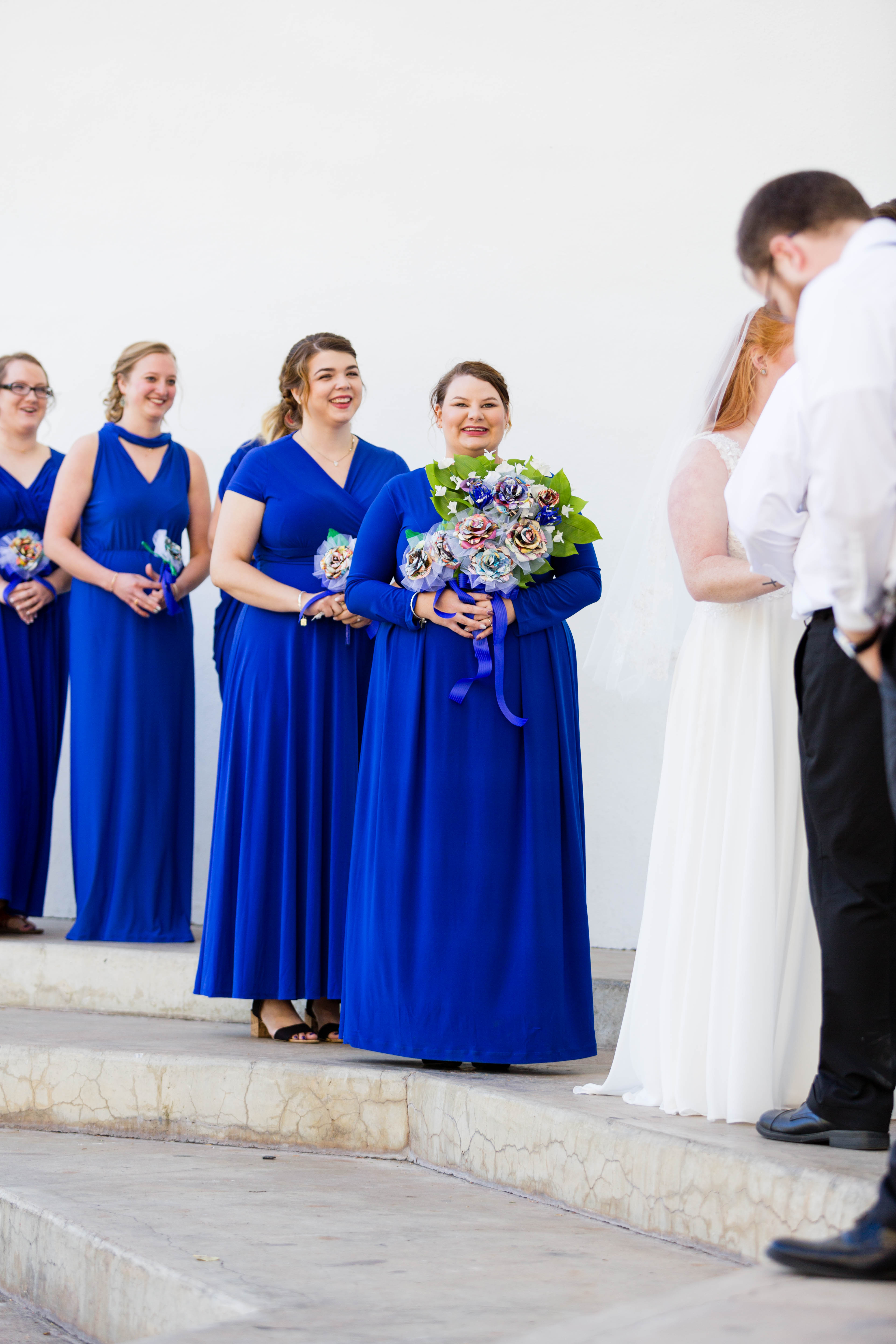 bridesmaids smile during wedding ceremony