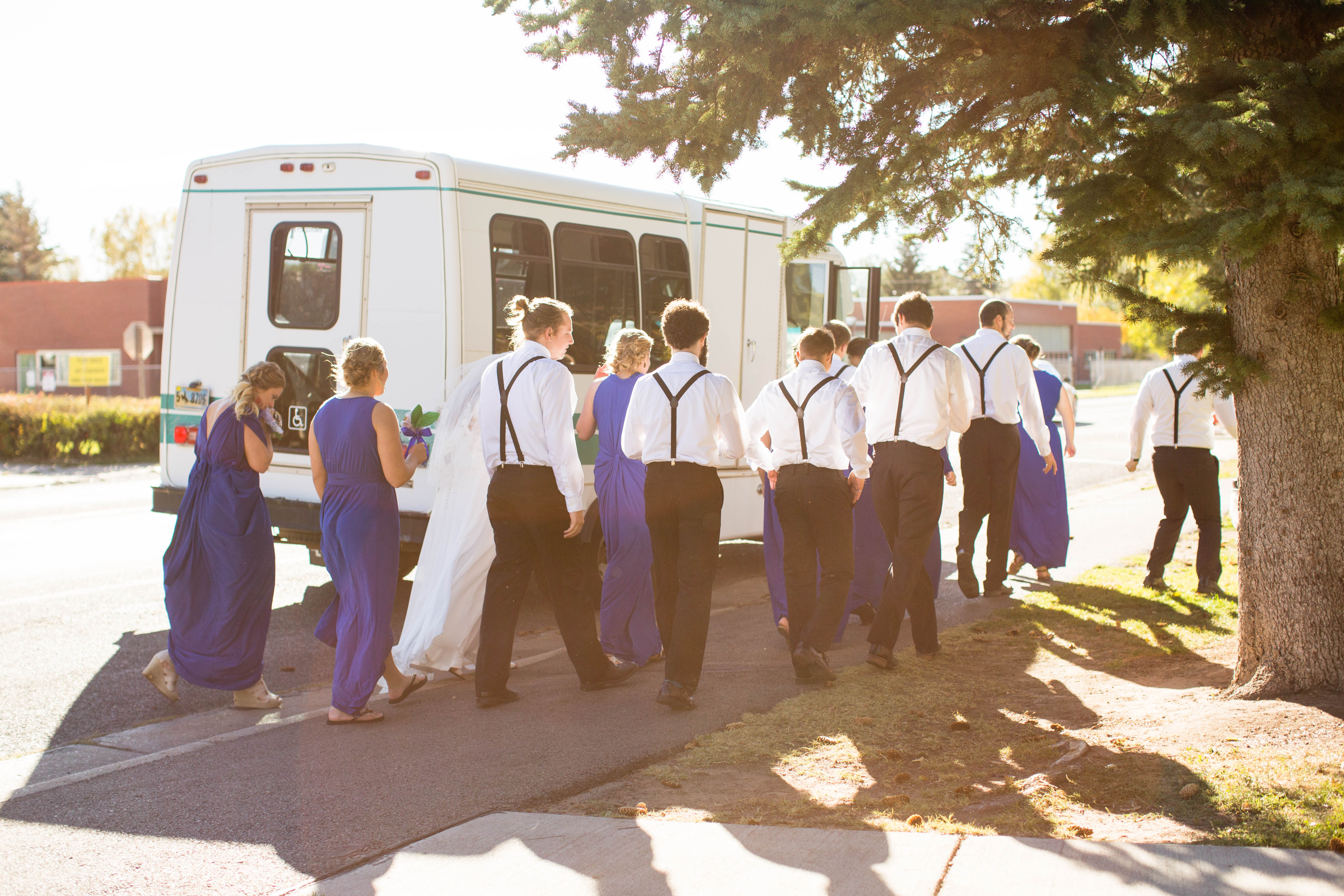 wedding party boards the shuttle bus before heading to the reception
