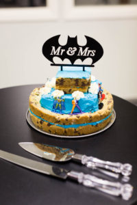 cookie wedding cake decorated with Batman figurines and blue icing