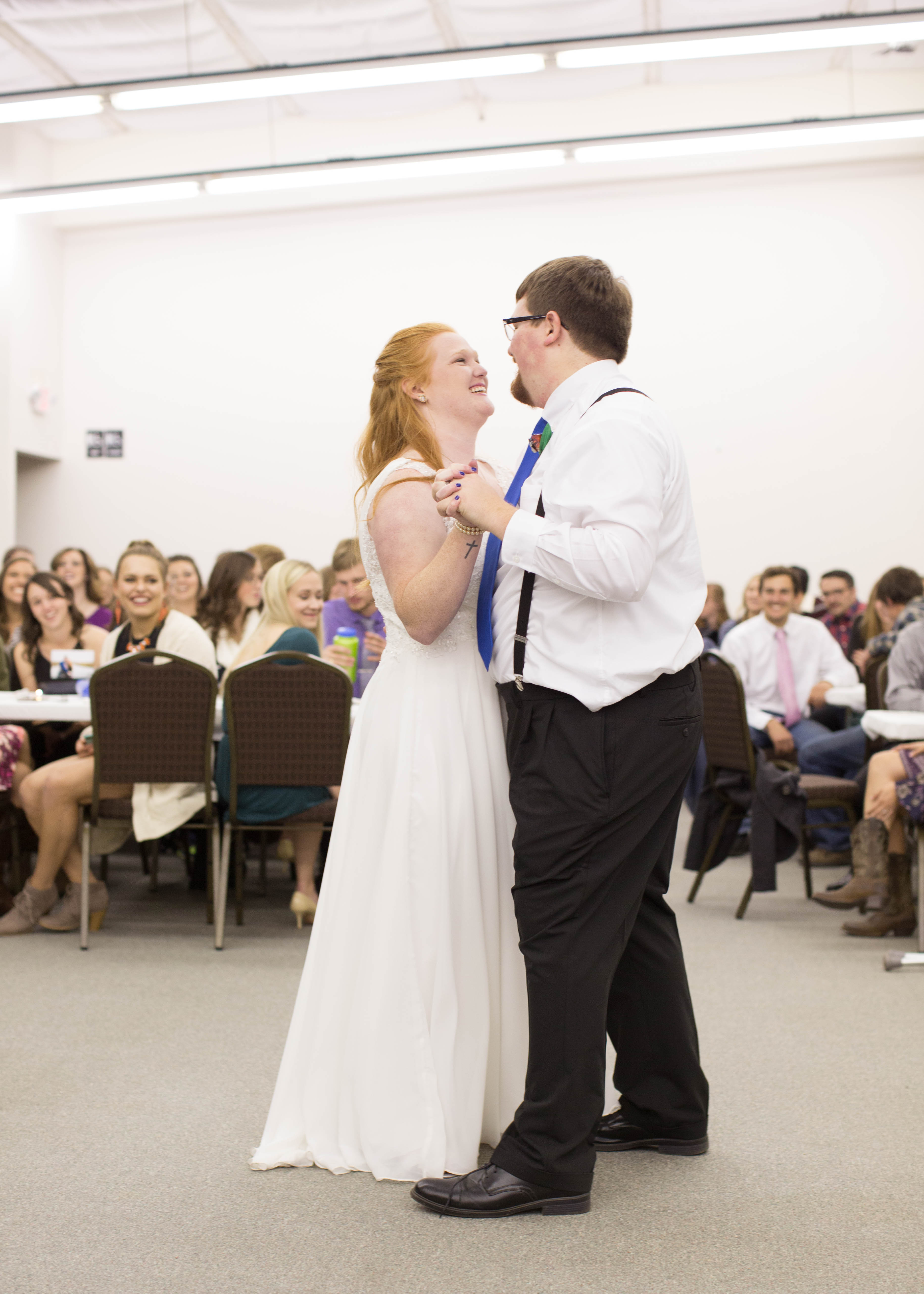 bride and groom smile at each other during first dance