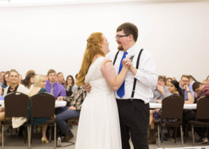guests watch bride and groom share their first dance