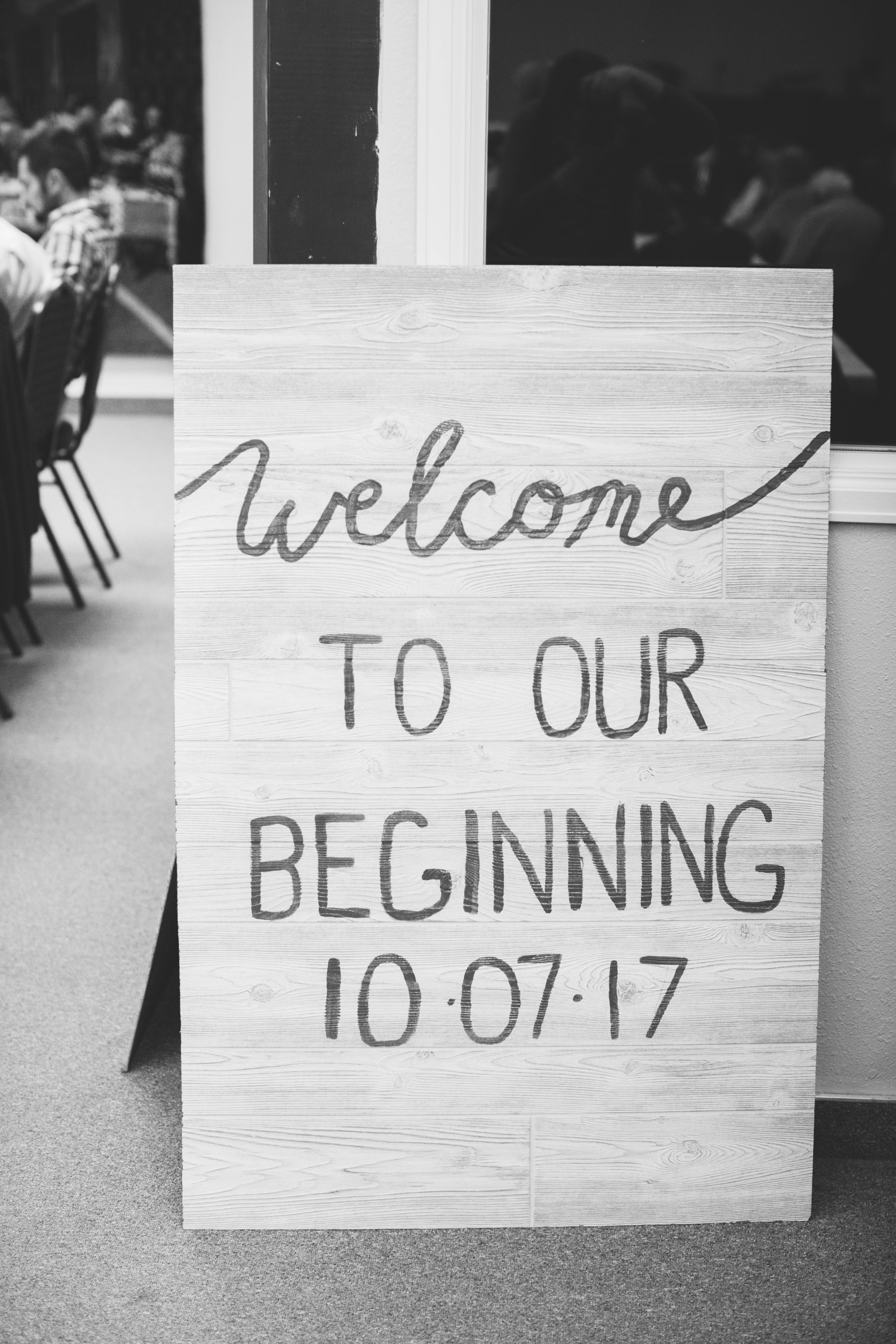 sign at a wedding reception that says "welcome to our beginning 10/07/2017"
