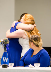 bride hugs maid of honor after her speech