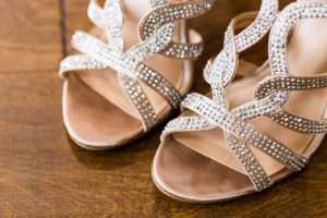 close up view of bride's strappy tan and crystal studded heels