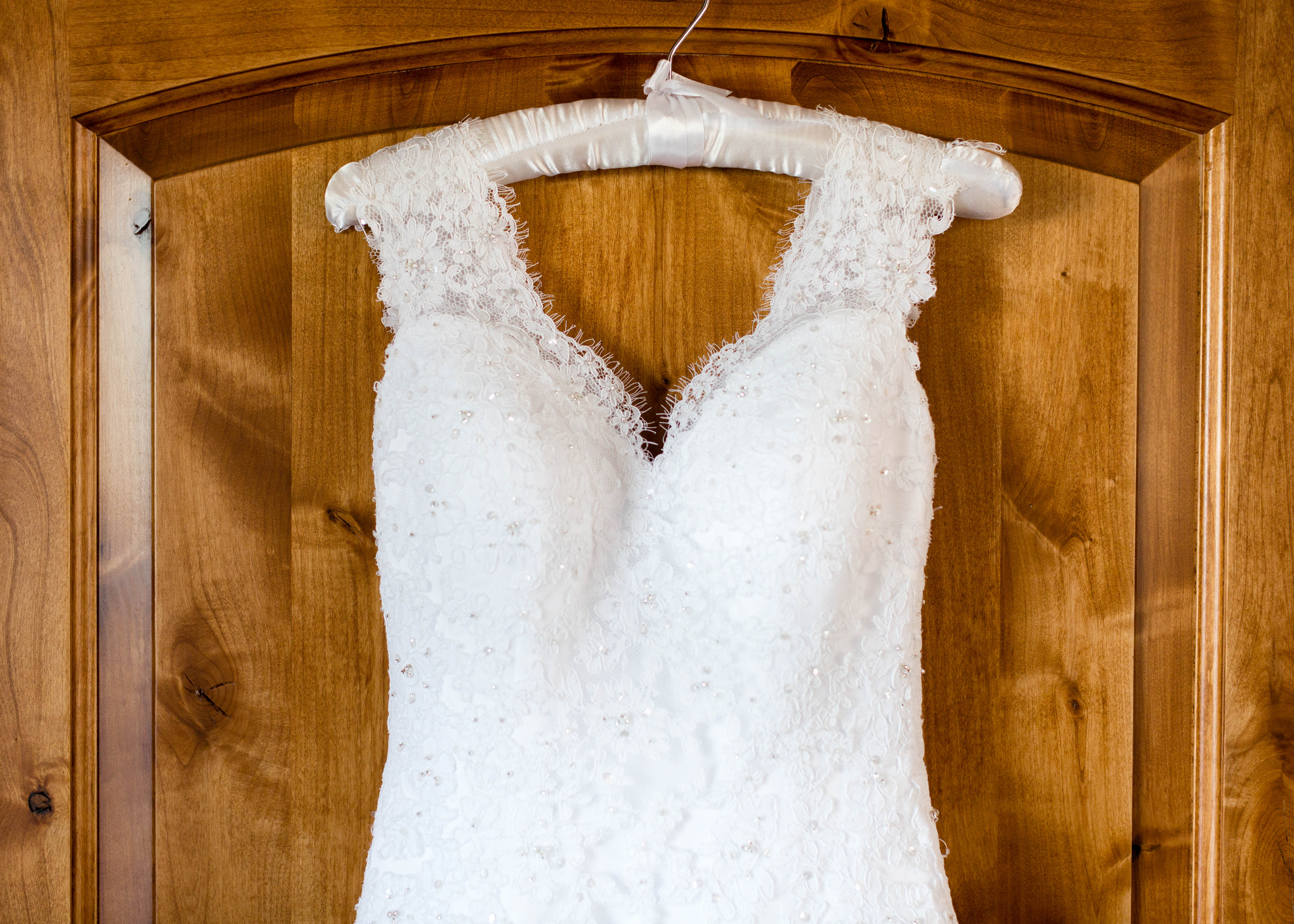 closeup of the Princess neckline of a beaded lace wedding dress