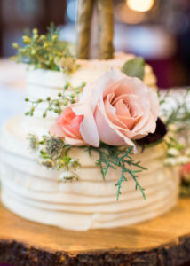 wedding cake with buttercream frosting and light pink garden rose details