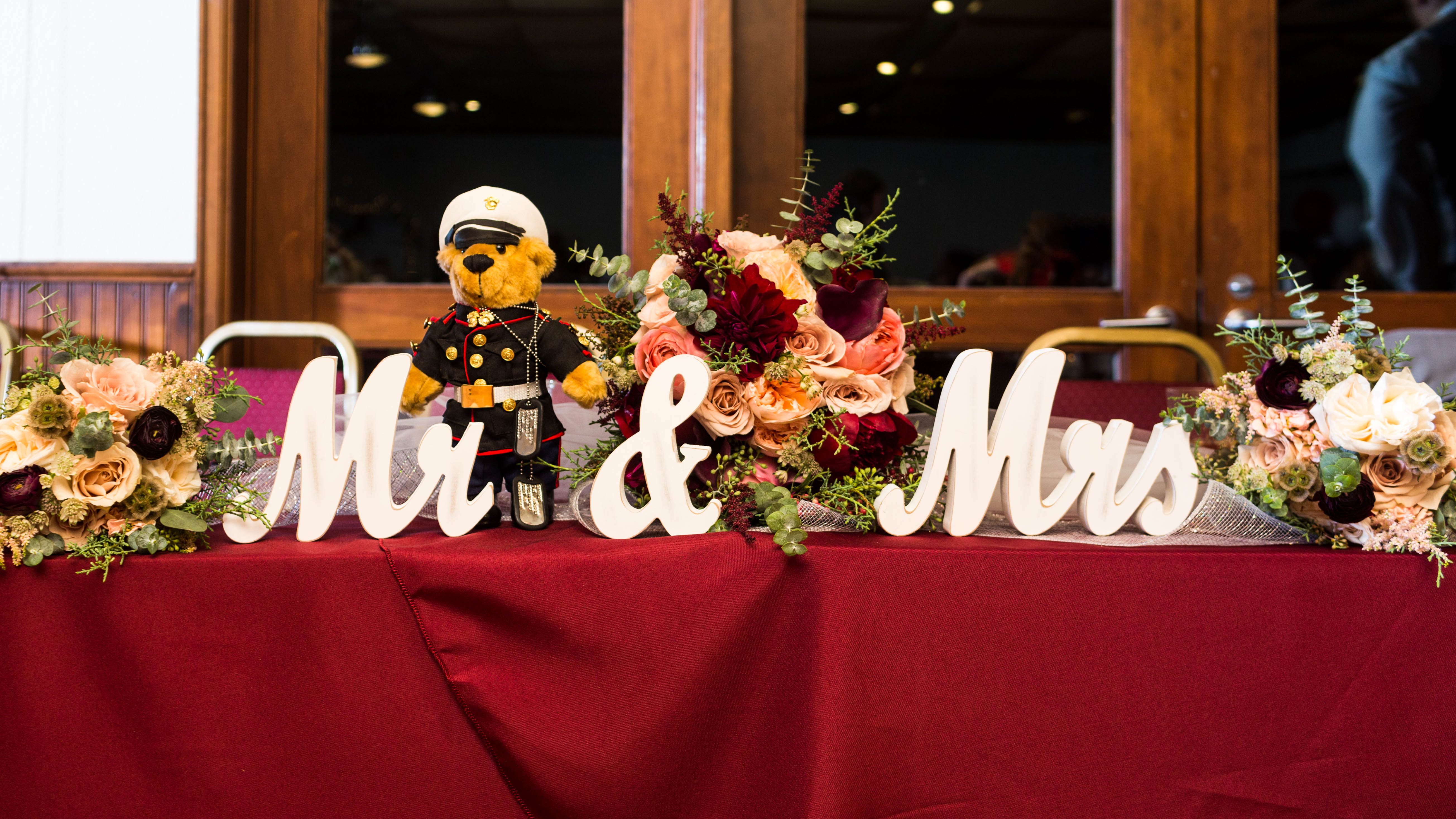 white wooden Mr. and Mrs Sign at the head table