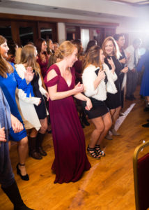 guests dance in a row during reception