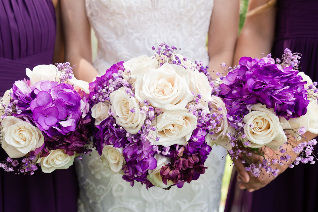 close up of bride and bridesmaids holding bouquets