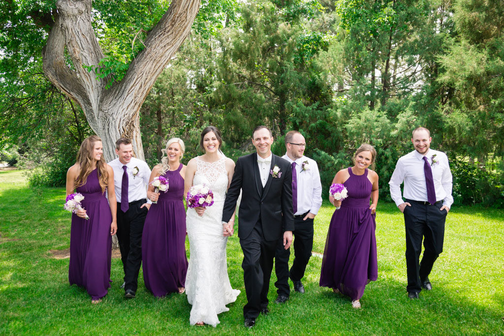 bride and groom walk with wedding party