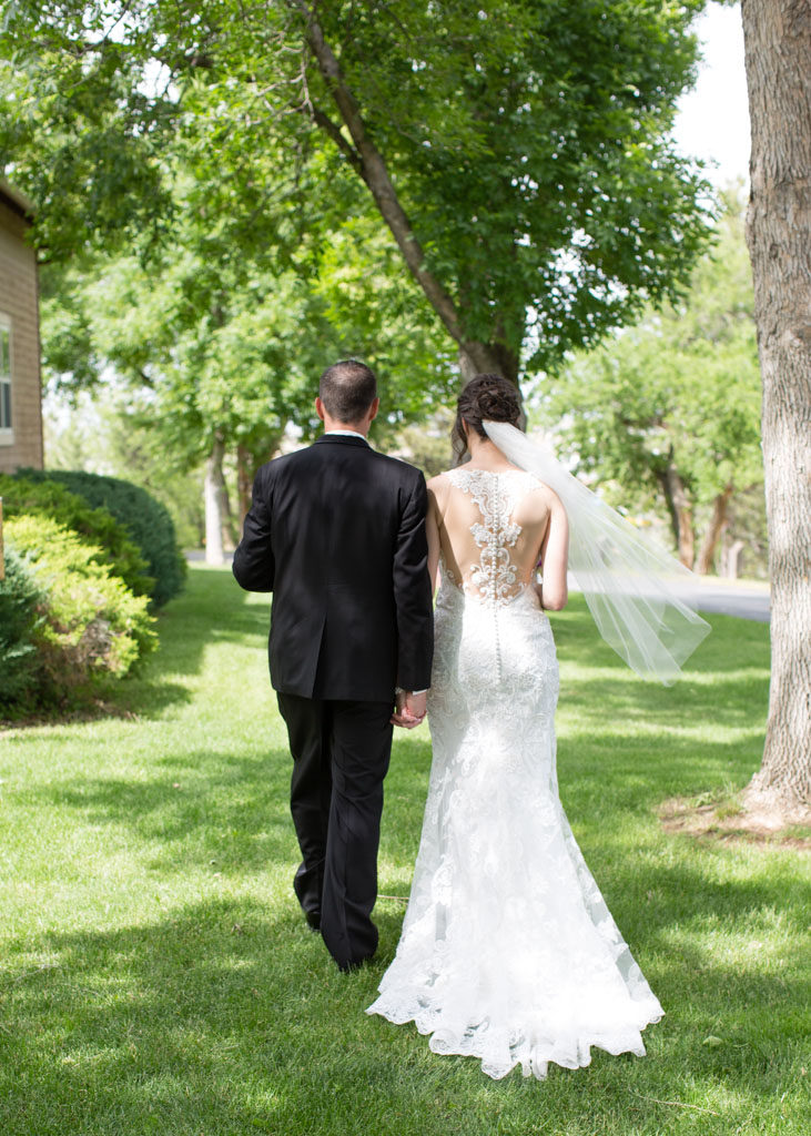 bride and groom walk away from camera