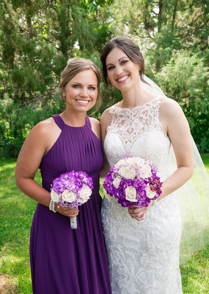 brie poses with bridesmaid in garden