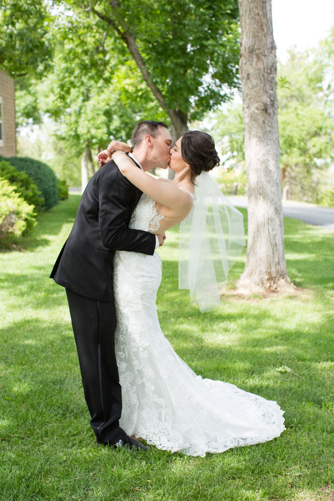 bride and groom kiss under cottonwood tree